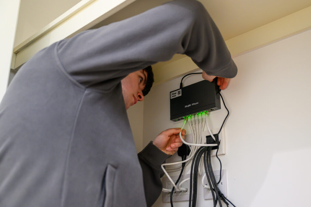 Klas Services technician installing network cabling and equipment